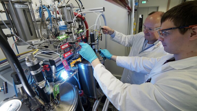 Two chemists are working on a polyethylene oxide reactor